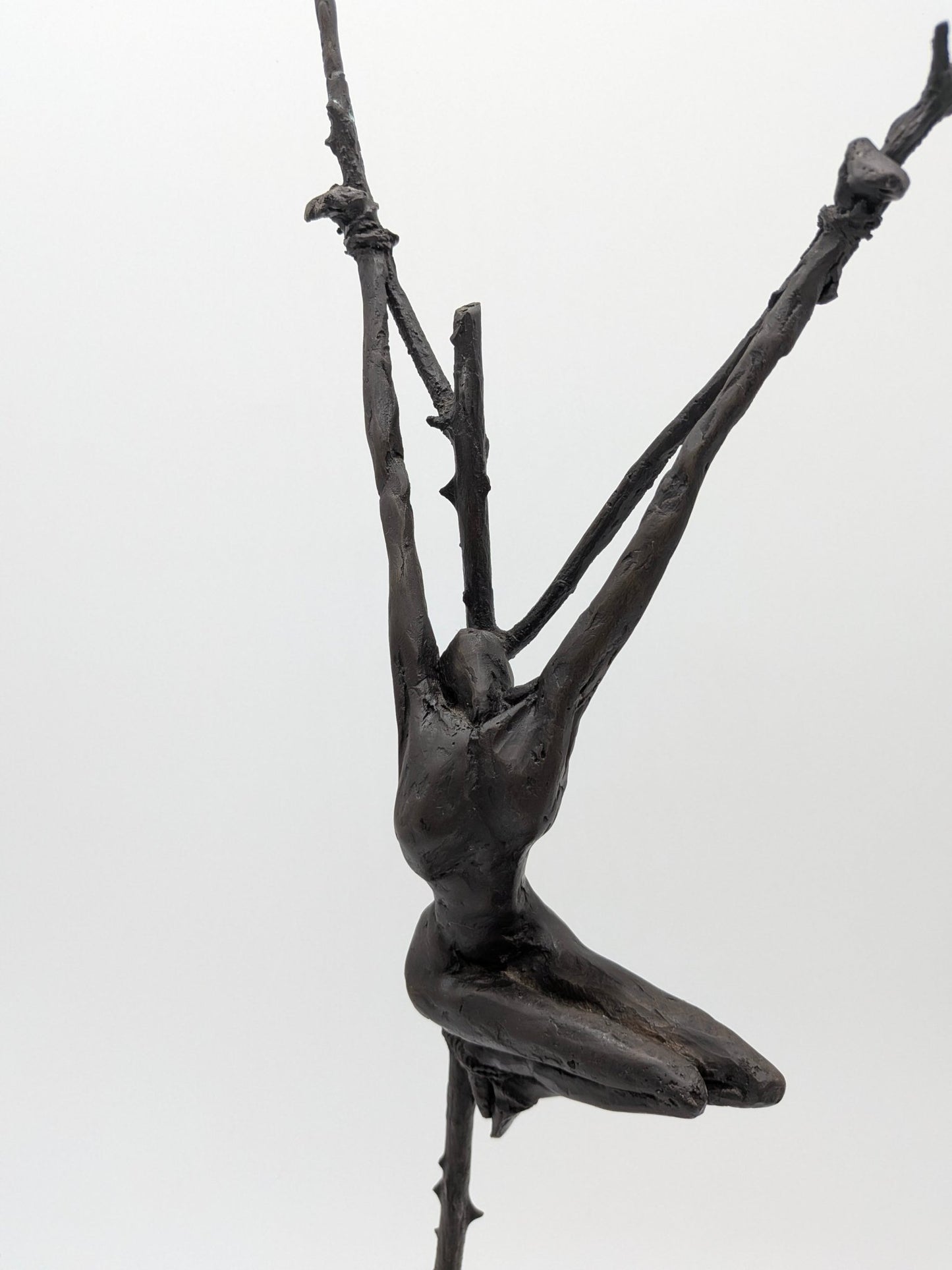 Brons sculptuur met kruisiging op sokkel dichtbij